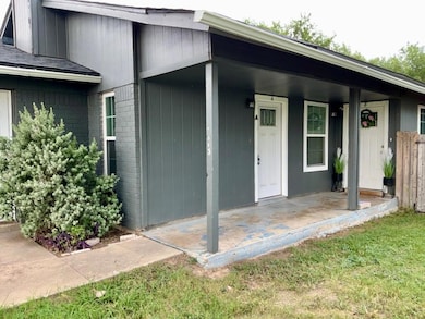 Doorway to property featuring brick siding and a 