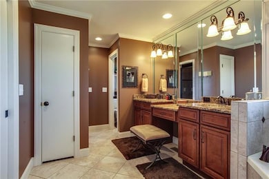 The master bathroom has double vanities, a large soaking tub, and beautiful tile floors. The master closet, located right off the bathroom, has built in shelves!