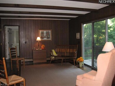 Family room features fireplace, access to back yard, beautiful hardwood flooring and beamed ceiling.