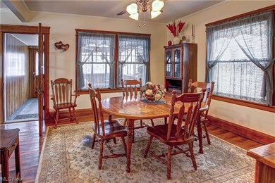 Dining space with a healthy amount of sunlight and hardwood / wood-style floors