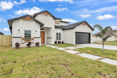 View of front of home with a garage and a front lawn