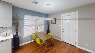 Dining space with light wood-type flooring and ba