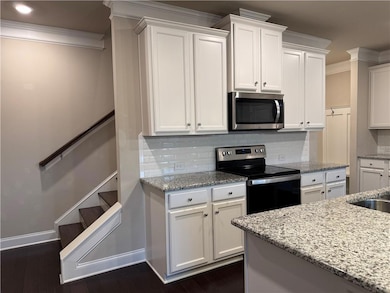 Kitchen with dark wood finished floors, stainless 