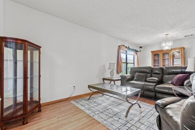 Living area with light wood-style floors, a chand