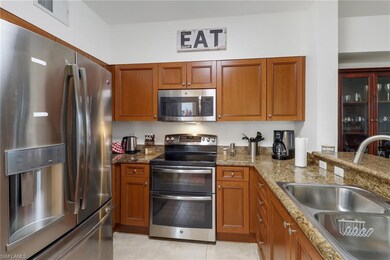 Kitchen featuring light stone counters, stainless 