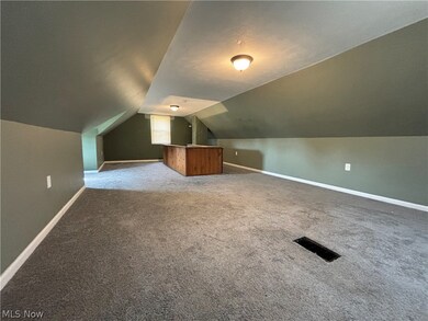 Bonus room featuring carpet flooring and lofted ceiling