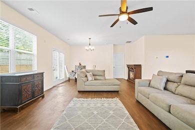 Living area featuring a chandelier, wood finished 