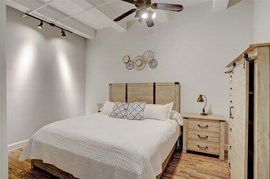 The hardwood floors extend into the primary bedroo