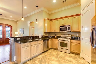 Custom wood cabinets w/SS appliances, and granite