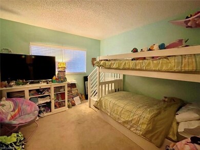 Bedroom featuring a textured ceiling and carpet fl