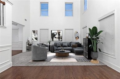 Living room featuring visible vents, baseboards, a