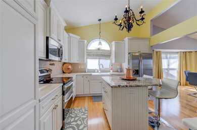The kitchen has stainless steel appliances, soft c