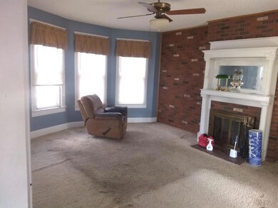 Complete with Brick Fireplace and Mirror above man