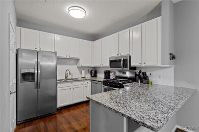 Kitchen with white cabinetry, stainless steel appl