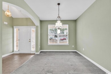 Foyer entrance featuring carpet floors and a notab