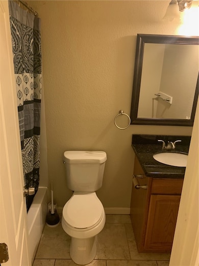 Bathroom featuring tile patterned floors, vanity,