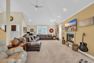 Living room with crown molding, high vaulted ceili