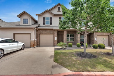 View of front facade with driveway, stucco siding