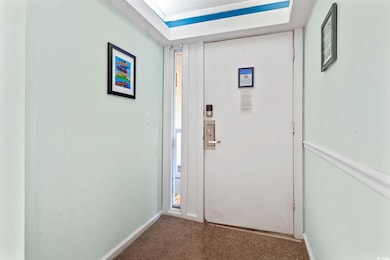 Hall with carpet flooring and baseboards
