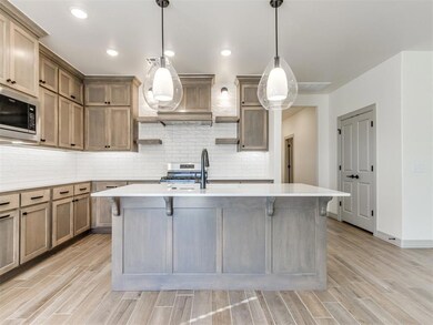 Kitchen with sink, a breakfast bar area, hanging l