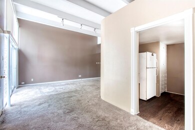 Spare room featuring carpet and rail lighting