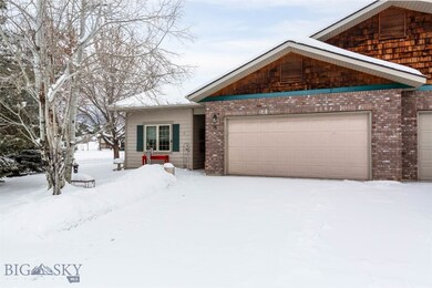 Two car garage with a large driveway