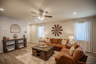 The living room boasts tall ceilings and a cozy atmosphere. Come in, sit down and cuddle up for movie night.