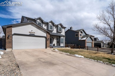 Traditional home with concrete driveway, fence, an