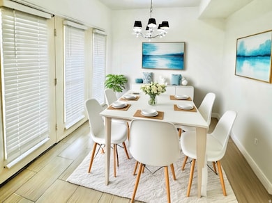 Dining area with a chandelier and light wood finished floors