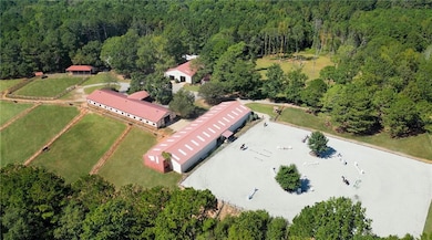 Main barn, indoor arena, and outdoor arena