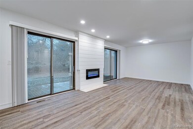 Unfurnished living room with light wood-style floors, a fireplace, and recessed lighting