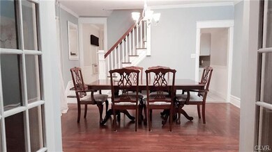 Spacious Dining Room with more hardwood and stairs