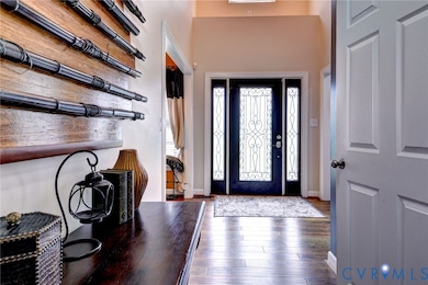 Entryway featuring baseboards and wood finished floors