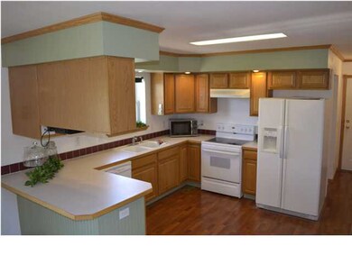 Spacious Kitchen with eating bar and wood laminate