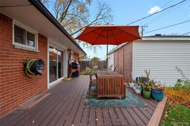 Wooden terrace with outdoor dining space and a grill