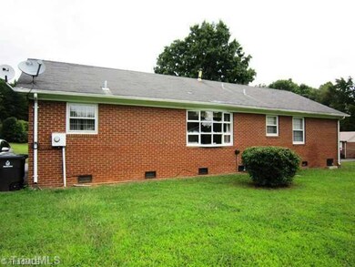 Exterior Front. View of back yard with chain link fence.