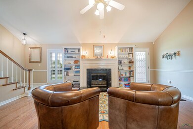 Living room featuring a tile fireplace, wood-type 