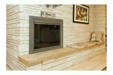 Kitchen. Gas fireplace, with stone face, creates a