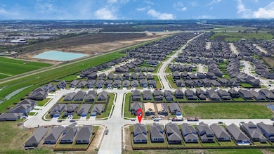 An aerial view of a spacious subdivision lot, high