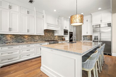 This spacious kitchen features elegant white cabin