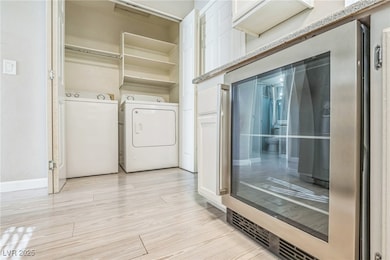 Washroom with washer / clothes dryer and light woo