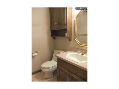 The half bathroom features a pretty vanity and til