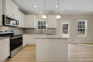 Ample amount of cabinetry with a large Pantry tuck away for maximum use of the Kitchen. The rear door leads to your Covered Porch and a view of the yard with privacy from the trees in the back. The afternoon shade will have you using this area a lot when the weather allows.