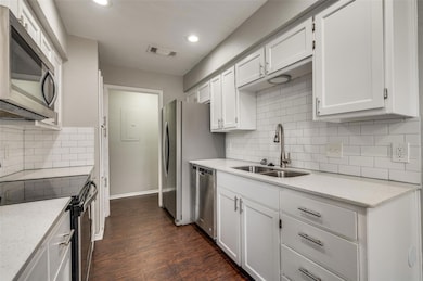 Kitchen with a sink, stainless steel appliances, v