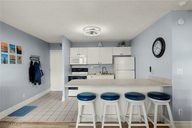 Kitchen featuring light countertops, white applian