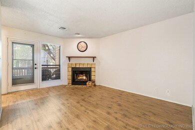 Unfurnished living room featuring wood finished fl