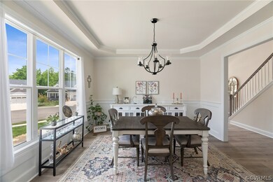 Dining space featuring a chandelier, LVP, a tray c