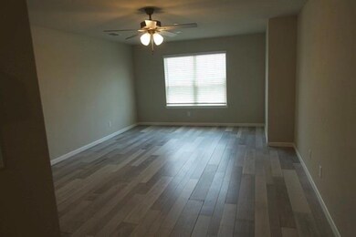 Spare room with wood-type flooring and ceiling fan