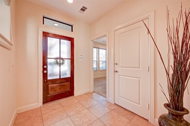Nice tiled entryway features tile flooring, canned lighting, leading to secondary en suite,  two car garage door.