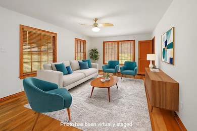 Living area featuring a ceiling fan and light woo